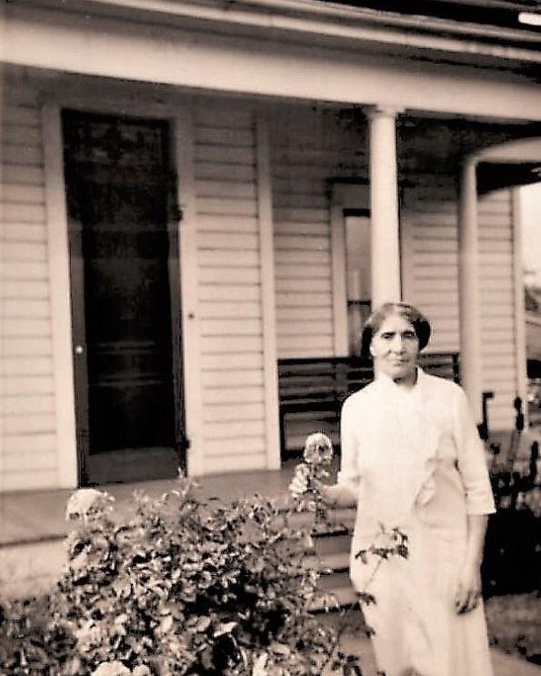 Nettie Asberry in front of her home